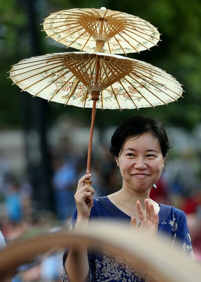 Yunung Lin marches with the Overseas Chinese LDS Pioneers Association in the Days of '47 Parade in Salt Lake City on Wednesday, July 24, 2019.