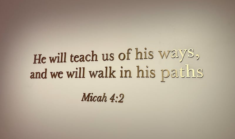 An image is shown of a scripture on the wall at the start of the Inside a Temple tour at the Salt Lake Temple Visitors' Center.