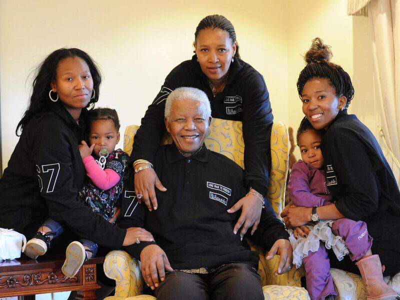 In this hand out photograph supplied by Peter Morey Photographic for the Mandela family, showing former South Africa president Nelson Mandela, center, with family members left to right Zaziwe Manaway, Ziphokazi Manaway, Zamaswazi Dlamini and Zamak Obiri a