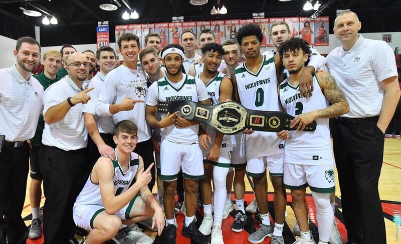 The Utah Valley men's basketball team poses after defeating Long Beach State, 87-72, on Wednesday to claim the MGM Main Event Middleweight title at Cox Pavilion in Las Vegas.