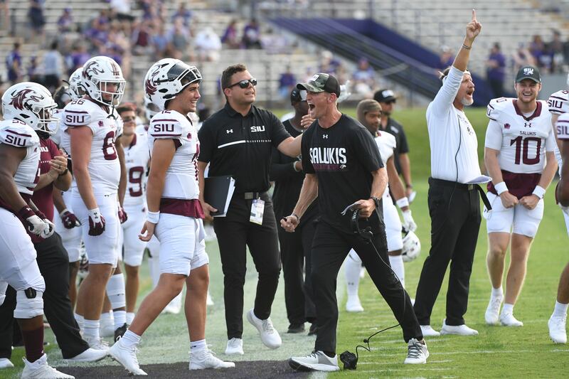 Southern Illinois head football coach Nick Hill, right, celebrates against Northwestern, during the second half of an NCAA college football game Saturday, Sept. 17, 2022, in Evanston, Ill. (AP Photo/Matt Marton