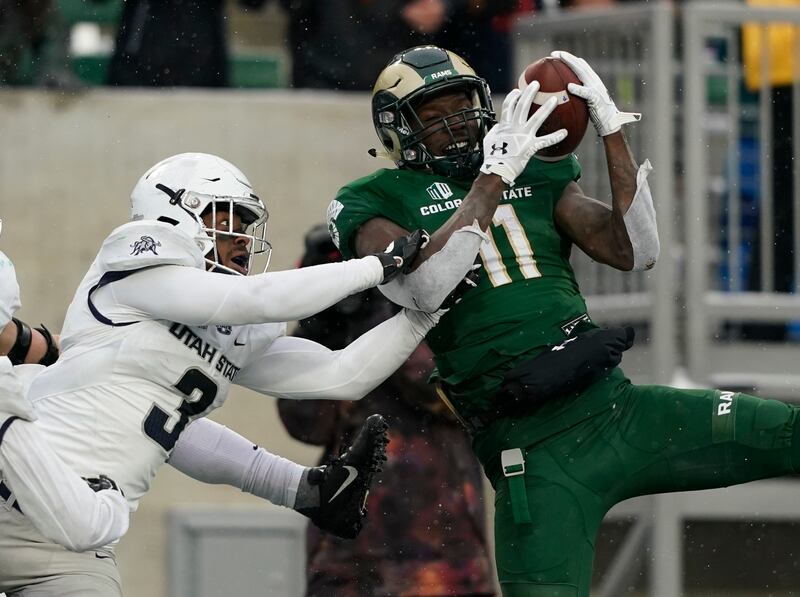 Colorado State wide receiver Preston Williams (11) pulls in a would be game-winning touchdown pass in the end zone with no time left on the clock against Utah State safety Jontrell Rocquemore (3) during an NCAA football game Saturday, Nov. 17, 2018, in Fo
