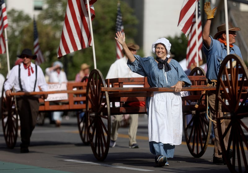A woman marches with the Sons of Utah Pioneers in the Days of ’47 Parade in Salt Lake City on Friday, July 23, 2021.