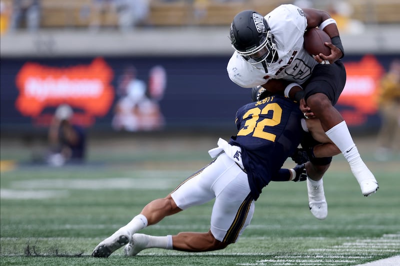 UNLV running back Aidan Robbins is tackled by California safety Daniel Scott during a game in Berkeley, Calif., Sept. 10, 2022.