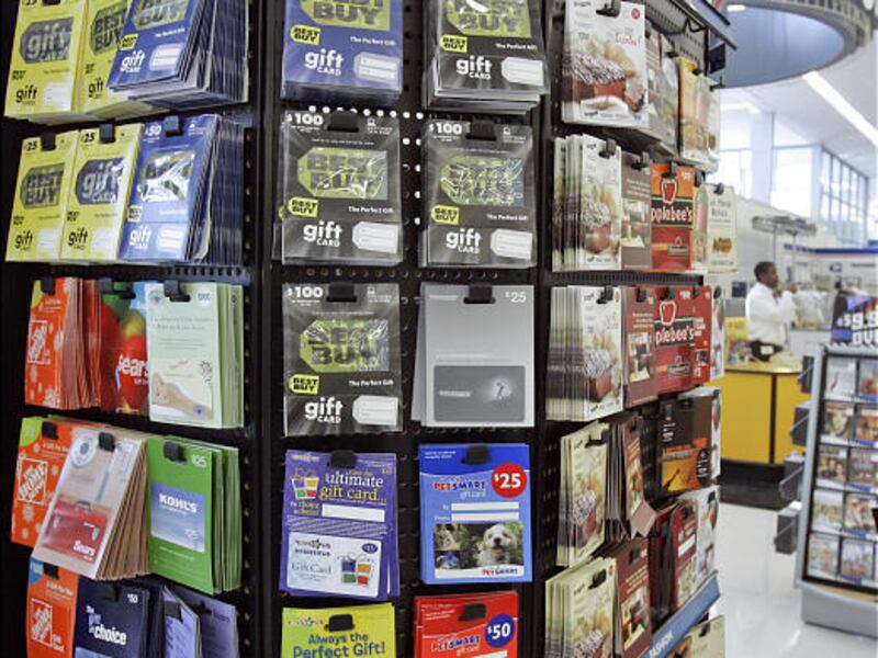 Gift cards for various retailers are offered for sale at a supermarket in Omaha, Neb. Many cards are redeemed in January.