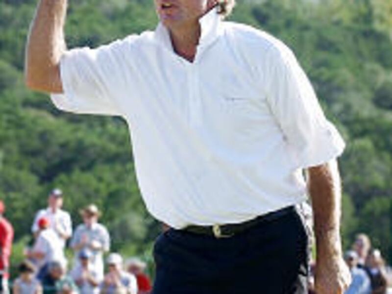 Tommy Armour III gestures to the crowd on the 18th green after winning the Texas Open with a PGA Tour 72-hole record score of 254.