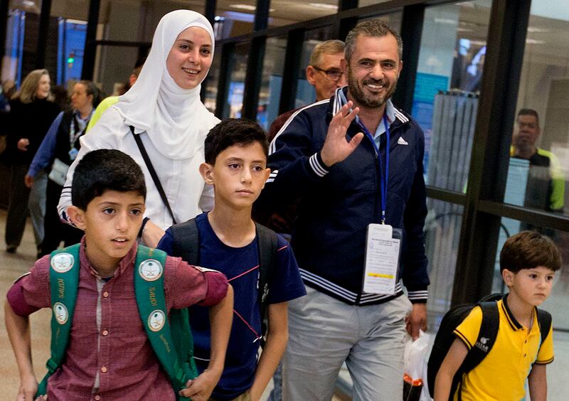 The Hamad family — Abdullah, Fahed, parents Baraa Huraideen and Malek, and Eslam — arrive at the Salt Lake City International Airport on May 25. The family is from Syria and was relocated to the U.S. through Catholic Community Services.