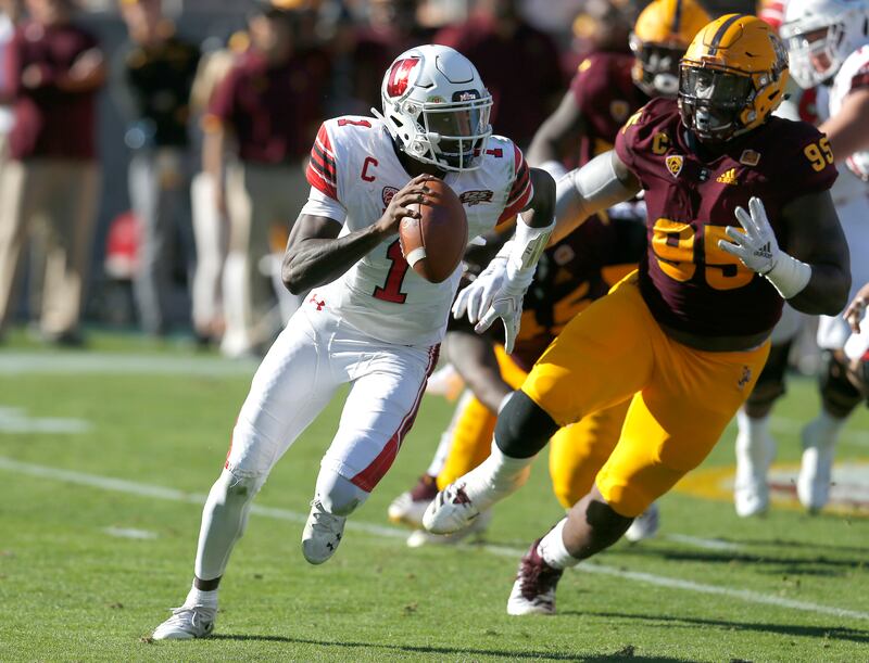 Utah quarterback Tyler Huntley (1) gets pressured by Arizona State defensive lineman Renell Wren in the second half during an NCAA college football game, Saturday, Nov. 3, 2018, in Tempe, Ariz. (AP Photo/Rick Scuteri)
