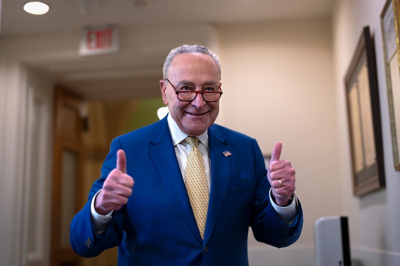 Senate Majority Leader Chuck Schumer, D-N.Y., signals success to reporters after a divided Senate passed an emergency spending package to provide send military aid to Ukraine and Israel, replenish U.S. weapons systems, and provide food, water and other humanitarian aid to civilians in Gaza in Washington on Feb. 13, 2024.