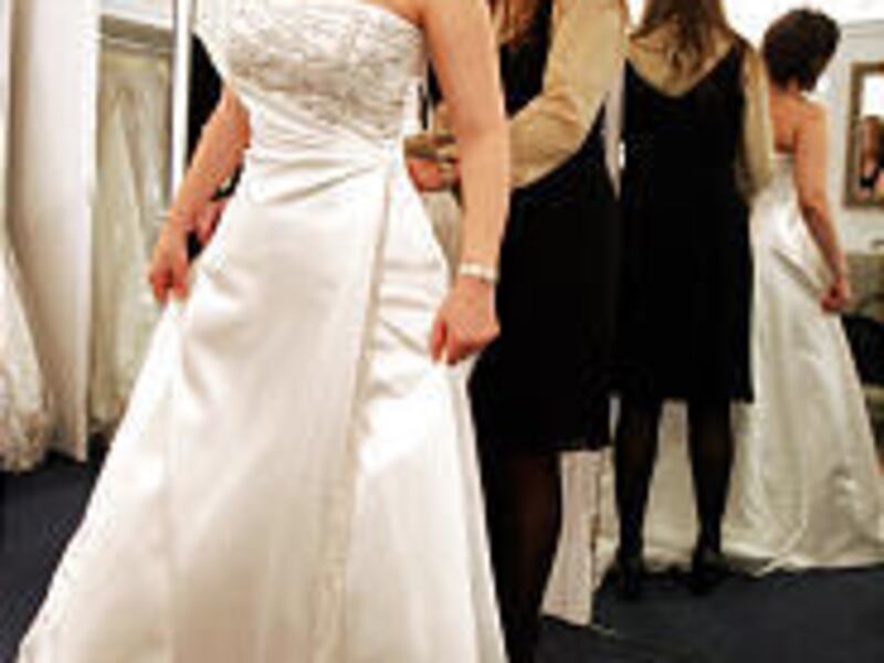 Sabrina Avila of Mexico is helped by bridal consultant Sabina Kerimovic in New York City.