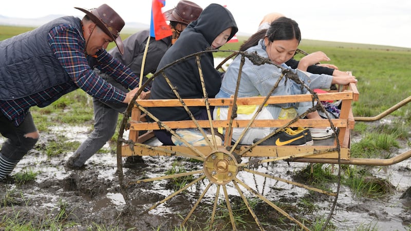 Youth and adult leaders in Mongolia trudge through muddy trails as part of the pioneer trek reenactment organized June 13-14, 2025, by the Darkhan district of The Church of Jesus Christ of Latter-day Saints.