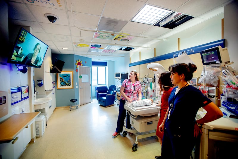 FILE - Julie Jenkins RN at Primary Children's in Salt Lake talks with Nurses Tassa Thornton, PICU RN, Cami Weir, RN and Janice Southern, RN educator in Provo with camera and TV in the rooms, Staff at Utah Valley Hospital show their new pediatric intensive