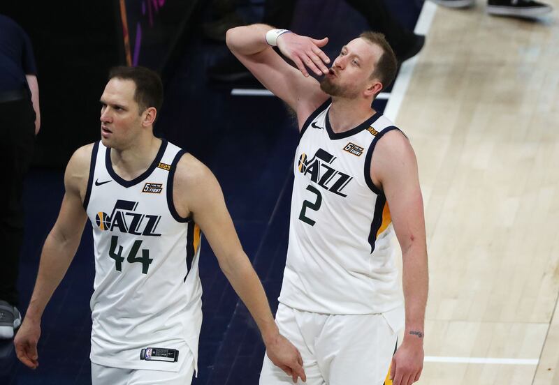 Utah Jazz guard Joe Ingles blows a kiss to his family as he and Utah Jazz forward Bojan Bogdanovic walk off the court.
