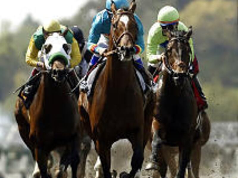 Brother Derek, center, leads the pack out of the starting gate at Santa Anita.
