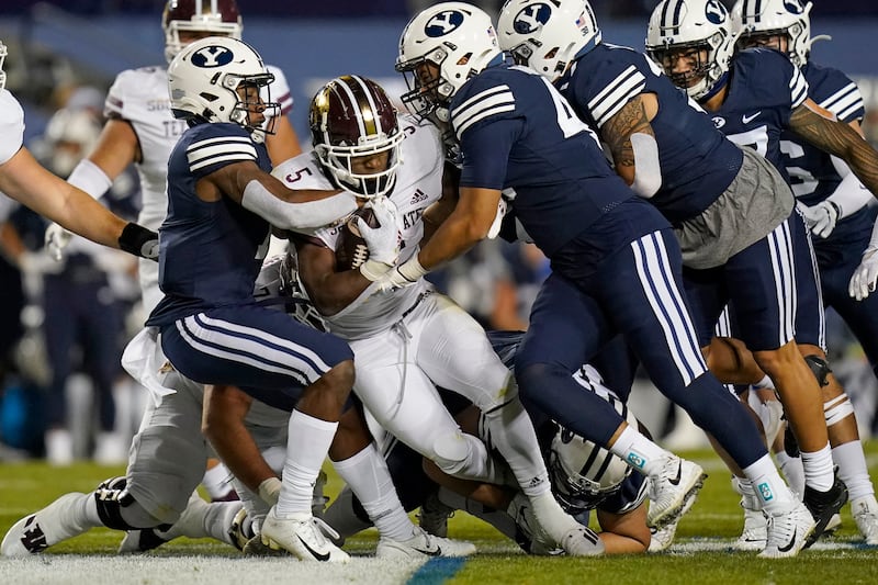 BYU’s Pepe Tanuvasa, right, and George Udo, left, tackle Texas State’s Brock Sturges Saturday, Oct. 24, 2020, in Provo, Utah.