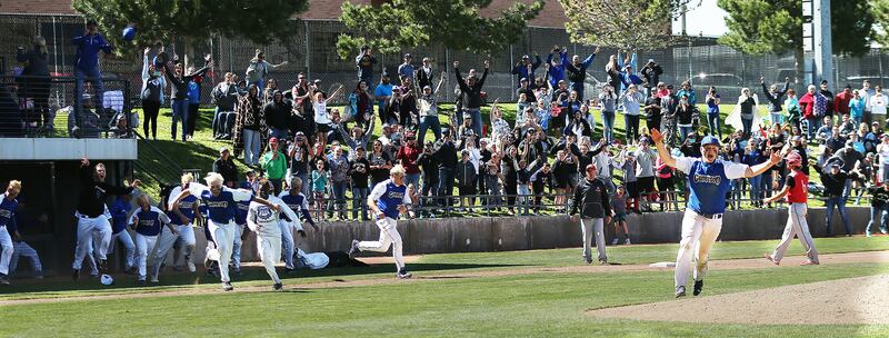 Gunnison players and fans begin their celebration as the Bulldogs defeat Grand for the 2A state baseball championship at Kearns High's Gates field on Saturday, May 13, 2017.
