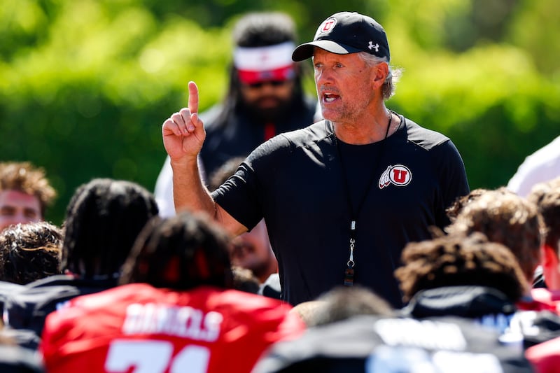 Utah coach Kyle Whittingham talks to his team following the first day of fall camp.