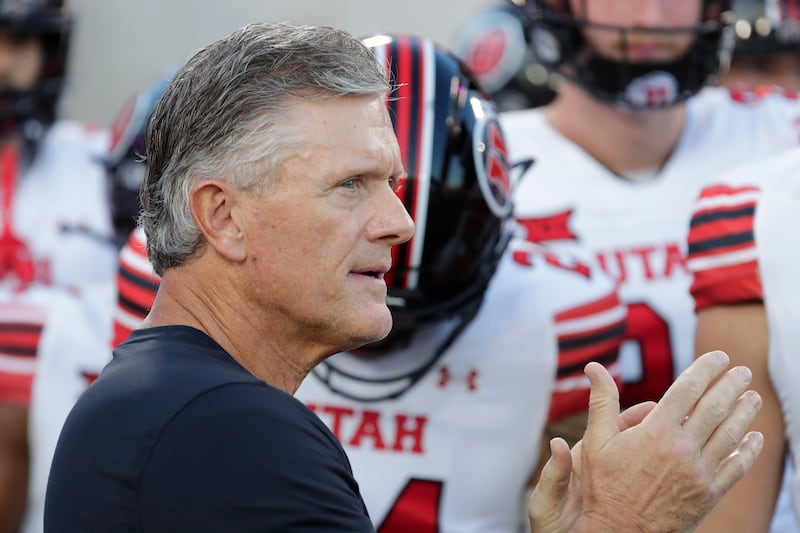 Utah head coach Kyle Whittingham, center, comes onto the field with his team before a game against Houston Saturday, Oct. 26, 2024, in Houston.