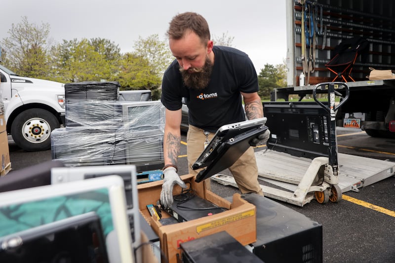 Lance Feher, of Tams Electronic Recycling, puts away laptops during Declutter Day at the University of Utah on April 22, 2022.
