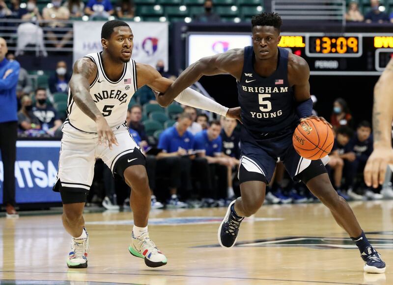 BYU forward Gideon George, wearing blue, tries to get by Vanderbilt guard Shane Dezonie