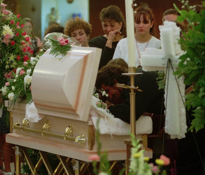 Friends and family say goodbye to Rosie Tapia during her funeral in 1995.