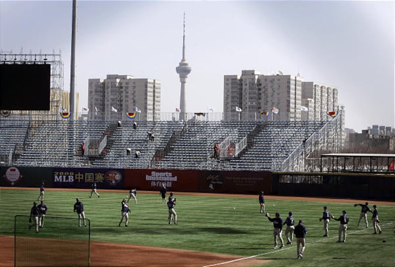 The San Diego Padres loosen up before playing the Los Angeles Dodgers in the first-ever MLB game in China at Wukesong Baseball Field on Saturday in Beijing.