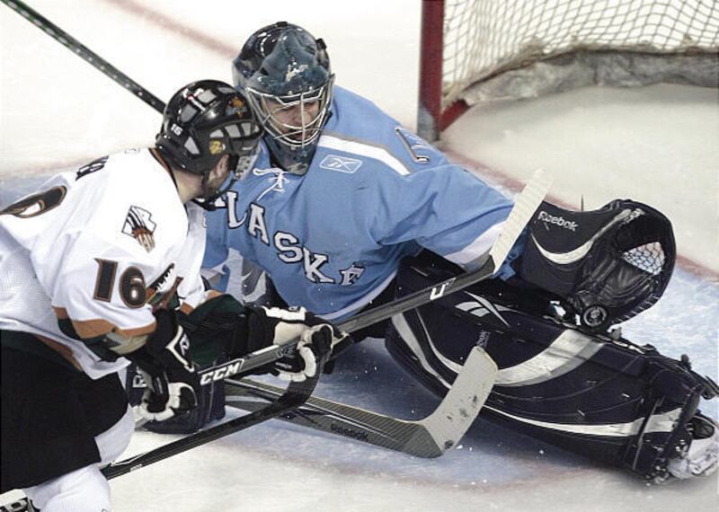 As a goalie for Alaska, Jean-Philippe Lamoureux stops a shot from Utah's Peder Skinner a season ago.