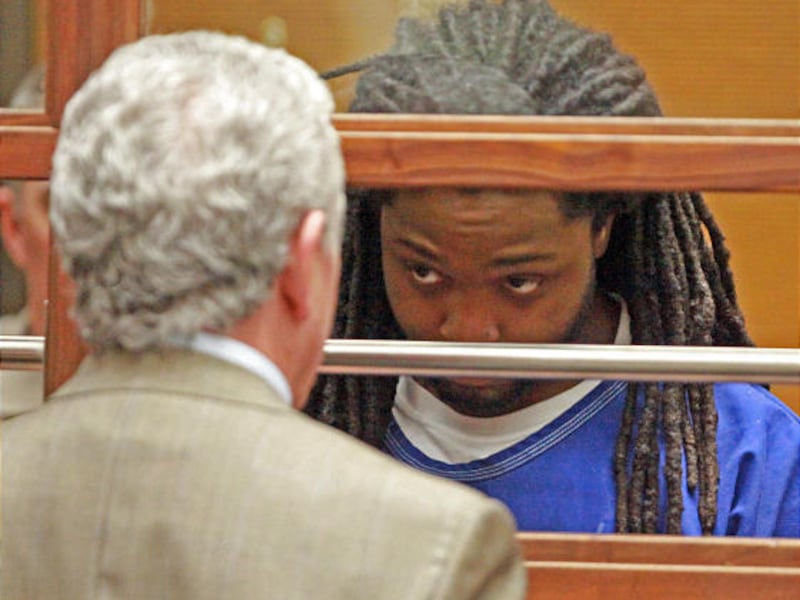 Aubry Berry, a suspect in the shooting death of rapper Dolla, appears at a hearing with his attorney, Howard Price, in a Los Angeles courtroom Friday.