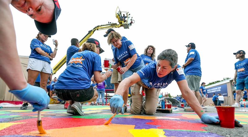 Delta flight attendant Loretta Martinez, of Park City, works with other volunteers from Delta Air Lines, Utah Community Action and the community in transforming an empty site into a kid-designed, state-of-the-art playground at James R. Russell Head Start