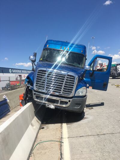 John Lindsey's semitrailer truck is pictured after it crashed onto a median on I-15 in South Salt Lake on Thursday May 2, 2019. The 72-year-old suffered a heart attack and was unconscious at the wheel.