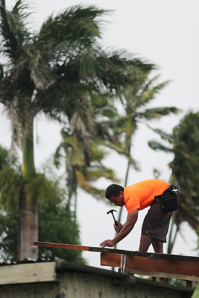 Volunteer Sione Teu helps build a new home for a family in need in Nuku'alofa, Tonga on Wednesday, May 22, 2019.