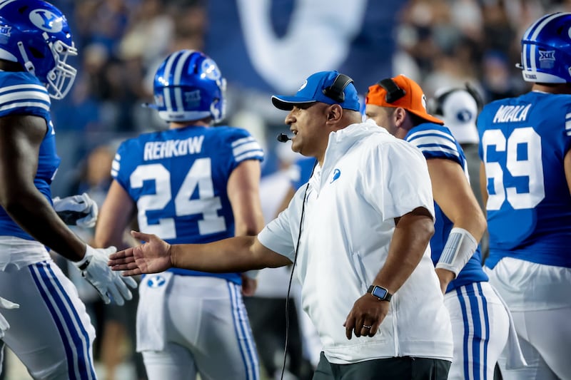 BYU coach Kalani Sitake celebrates with players after a touchdown during game against Sam Houston in Provo on Sept. 2, 2023.
