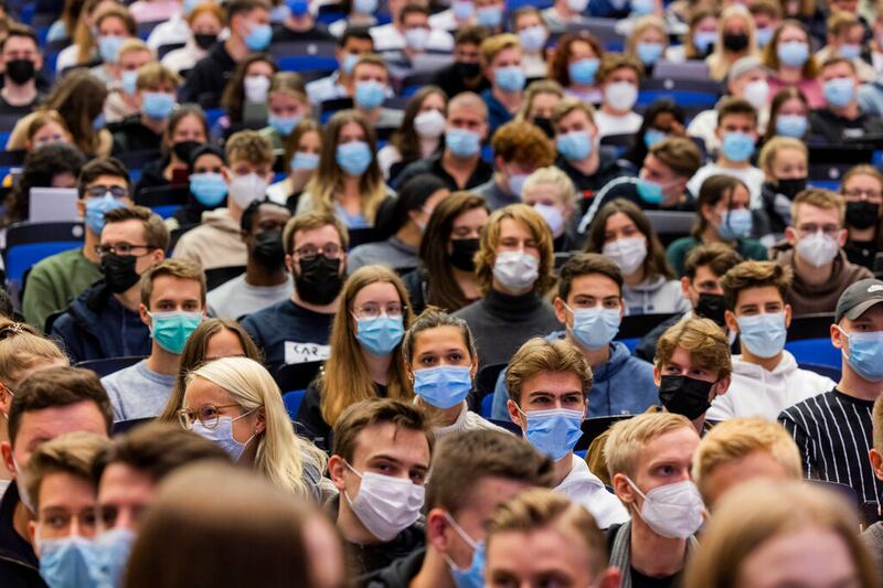 Students wear mouth-to-nose coverings.