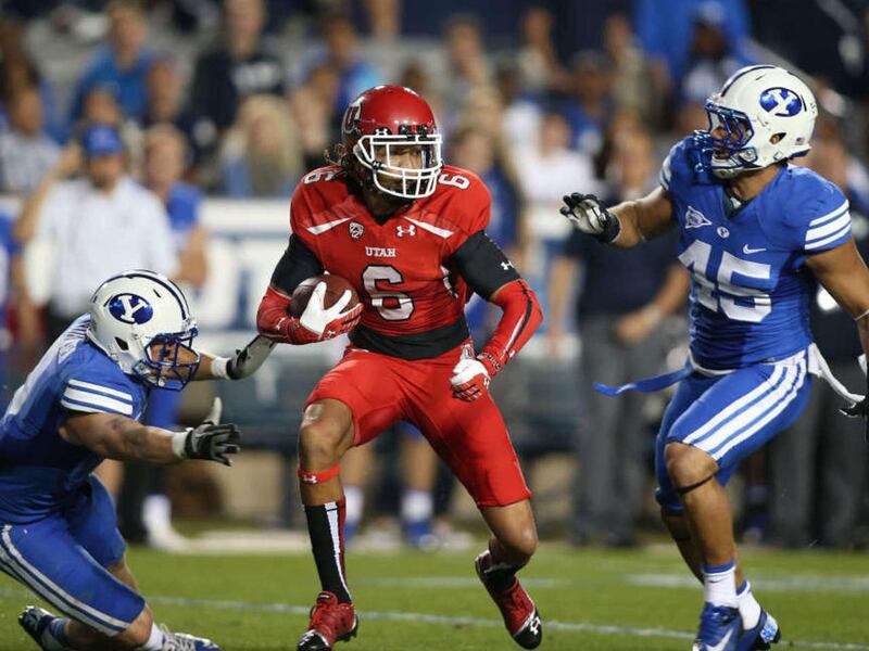 Utah Utes wide receiver Dres Anderson (6) runs by BYU's Daniel Sorensen , left, and Tyler Beck on the long play to set up a touchdown as the University of Utah and Brigham Young University play football Saturday, Sept. 21, 2013, in Provo.