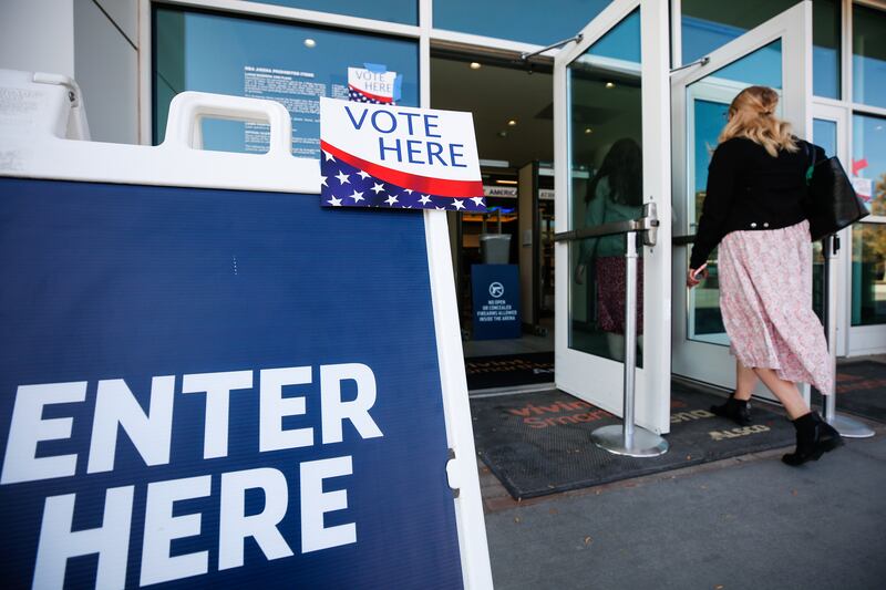 An ‘Enter Here’ sign is pictured in front of the Vivint SmartHome Arena during Election Day 2020.