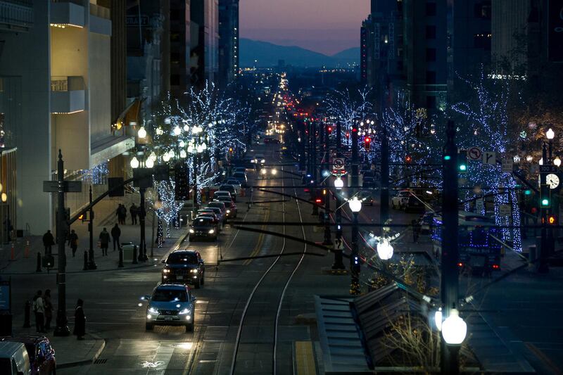 Pedestrians, cars and trains bustle along Main Street in downtown Salt Lake City on Wednesday, Dec. 7, 2016.