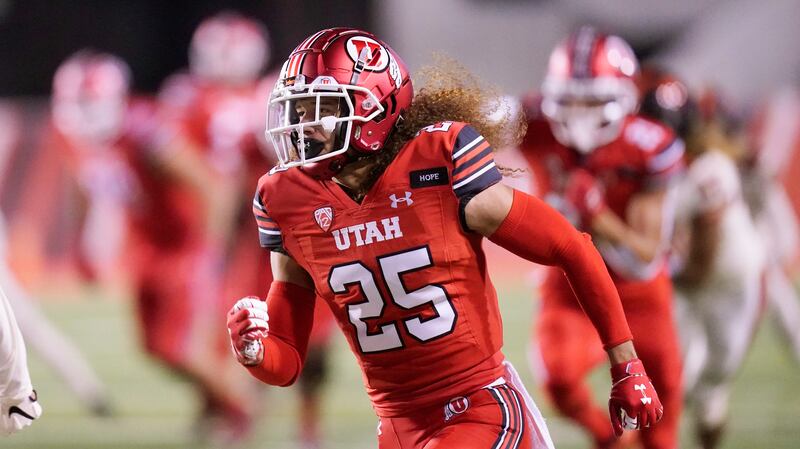 Utah cornerback Kenzel Lawler (wearing red) runs up field