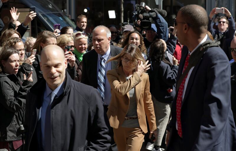 People photograph actress Lori Loughlin as she arrives at federal court in Boston on Wednesday, April 3, 2019, to face charges in a nationwide college admissions bribery scandal.