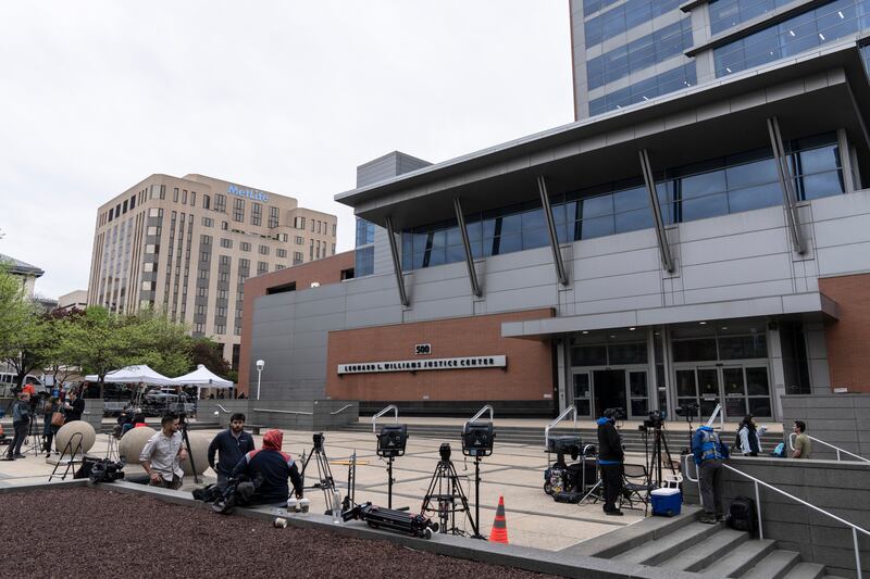 Members of the media gather outside the justice center in Wilmington, Del.