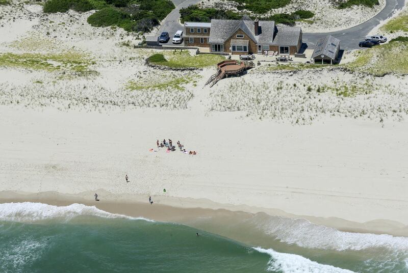 In this Sunday, July 2, 2017, photo, New Jersey Gov. Chris Christie uses the beach with his family and friends at the governor's summer house at Island Beach State Park in New Jersey. Christie is defending his use of the beach, closed to the public during