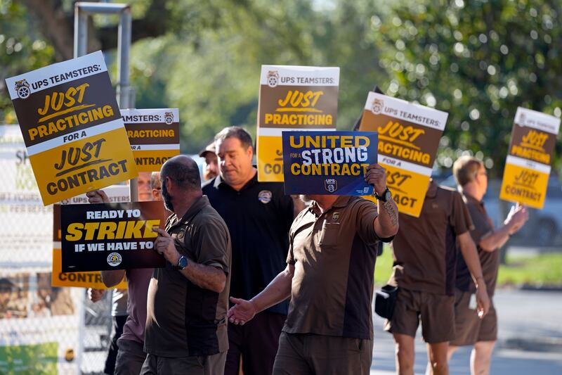UPS workers go through a rehearsal of a pending strike at the UPS Customer Center in Longwood, Fla.