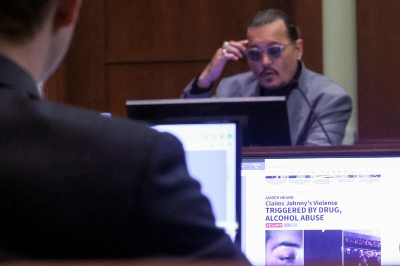 Actor Johnny Depp testifies, as an article seen on a screen is entered into evidence, during the trial at Fairfax County Circuit Court in Fairfax, Va., Wednesday, April 20, 2022.