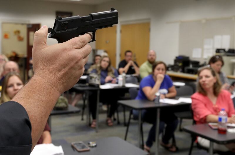 Detective Justin Mortensen shows schoolteachers different kinds of firearms during a class at the Utah County Sheriff's Office in Spanish Fork on Wednesday, June 12, 2019.