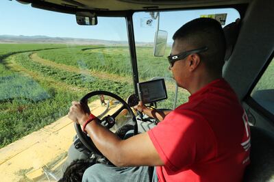 Andres Garcia swaths hay at M&K Farms in Centerfield on Friday, June 8, 2018. Sanpete County farmers say they have never seen the water supply as dire as this year.
