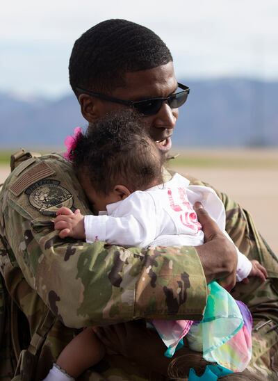 An airman hugs his child while greeting his family after returning home from a seven-month deployment to the Middle East with the 729th Air Control Squadron at Hill Air Force Base on Monday, April 29, 2019. The 128 airmen that deployed contributed to the