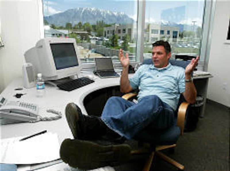 Darl McBride, chief executive of SCO Group of Lindon, discusses the IBM lawsuit with his attorneys via speaker phone during a teleconference in his office.