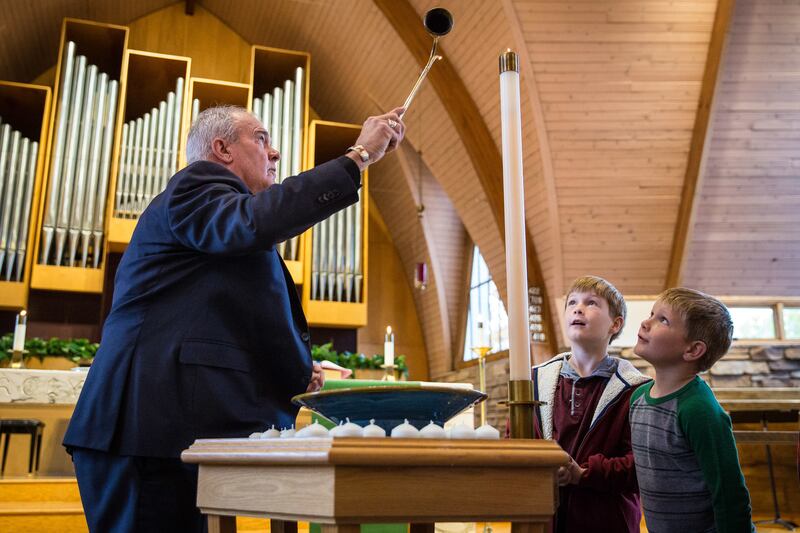 The Rev. Steve Klemz lights the candles to commemorate all the saints at Zion Evangelical Lutheran Church in Salt Lake City on Sunday, Nov. 4, 2018.