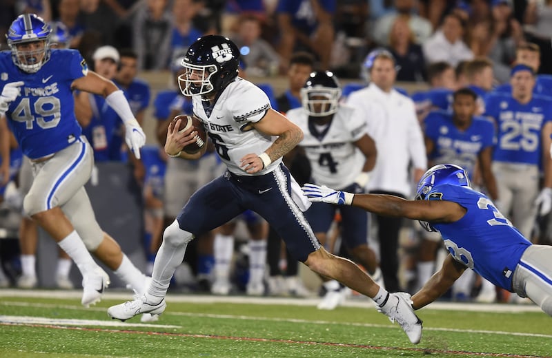Air Force’s Demonte Meeks misses a tackle on the Utah State quarterback Andrew Peasley during an NCAA college football game Saturday, Sept. 18, 2021, at Air Force Academy, Colo.