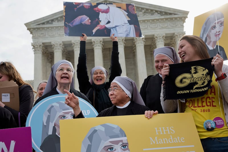 Nuns with the Little Sisters of The Poor, including Sister Celestine, left, and Sister Jeanne Veronique, center, rally outside the Supreme Court in Washington, Wednesday, March 23, 2016, as the court hears arguments to allow birth control in healthcare pl