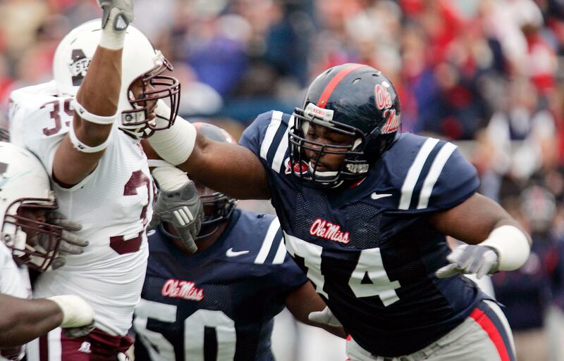 In this 2008 file photo, Mississippi State’s Tim Bailey (39) is shoved back by Mississippi offensive lineman Michael Oher (74) in Oxford, Miss.